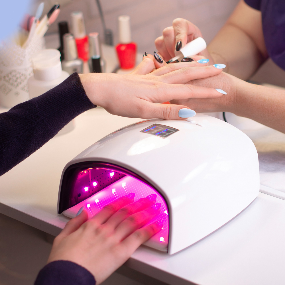 female-hand-with-manicure-nails-gel-polish-lamp-beauty-salon
